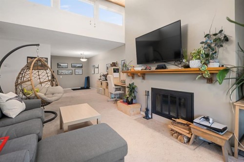 417-3730 50 Street Nw, Calgary, AB - Indoor Photo Showing Living Room With Fireplace