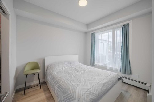 102-200 Shawnee Square Sw, Calgary, AB - Indoor Photo Showing Bedroom