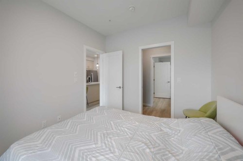 102-200 Shawnee Square Sw, Calgary, AB - Indoor Photo Showing Bedroom