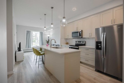 102-200 Shawnee Square Sw, Calgary, AB - Indoor Photo Showing Kitchen With Stainless Steel Kitchen With Upgraded Kitchen