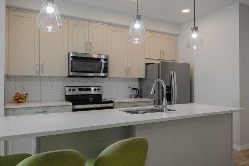 102-200 Shawnee Square Sw, Calgary, AB - Indoor Photo Showing Kitchen With Stainless Steel Kitchen With Upgraded Kitchen