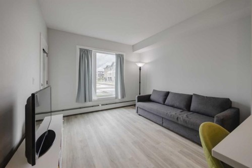 102-200 Shawnee Square Sw, Calgary, AB - Indoor Photo Showing Living Room