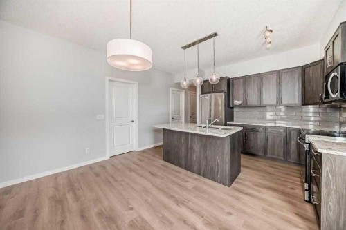 401-250 Fireside View, Cochrane, AB - Indoor Photo Showing Kitchen With Double Sink With Upgraded Kitchen