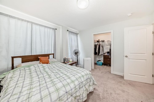 1703 Jumping Pound Common, Cochrane, AB - Indoor Photo Showing Bedroom