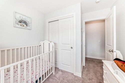 1703 Jumping Pound Common, Cochrane, AB - Indoor Photo Showing Bedroom