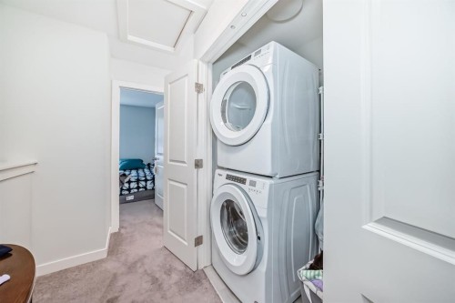 1703 Jumping Pound Common, Cochrane, AB - Indoor Photo Showing Laundry Room