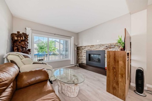 9 Copperpond Avenue Se, Calgary, AB - Indoor Photo Showing Living Room With Fireplace