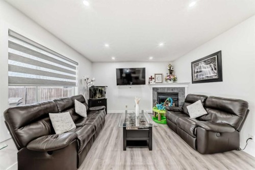 246 New Brighton Mews Se, Calgary, AB - Indoor Photo Showing Living Room With Fireplace