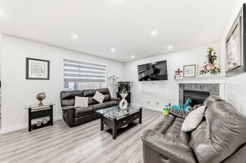 246 New Brighton Mews Se, Calgary, AB - Indoor Photo Showing Living Room With Fireplace