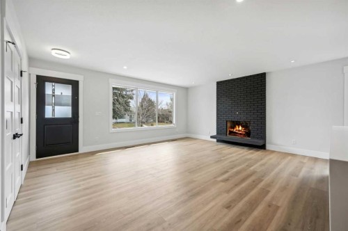 36 Maple Court Crescent Se, Calgary, AB - Indoor Photo Showing Living Room With Fireplace