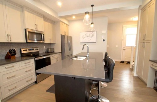 103 Sunrise Common, Cochrane, AB - Indoor Photo Showing Kitchen With Upgraded Kitchen