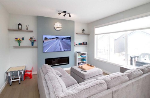 103 Sunrise Common, Cochrane, AB - Indoor Photo Showing Living Room With Fireplace