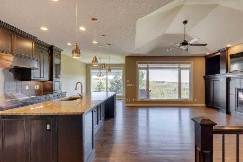 144 Tuscany Ravine Heights Nw, Calgary, AB - Indoor Photo Showing Kitchen With Fireplace With Upgraded Kitchen
