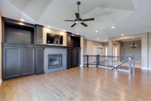 144 Tuscany Ravine Heights Nw, Calgary, AB - Indoor Photo Showing Other Room With Fireplace