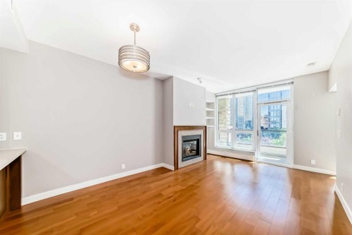 521-222 Riverfront Avenue Sw, Calgary, AB - Indoor Photo Showing Living Room With Fireplace