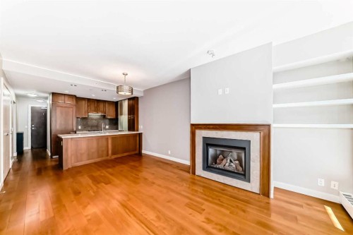 521-222 Riverfront Avenue Sw, Calgary, AB - Indoor Photo Showing Living Room With Fireplace