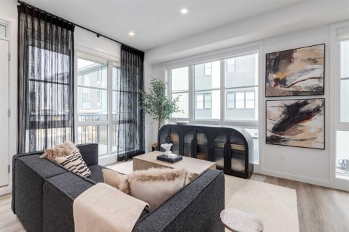 410-1453 Na'A Drive Sw, Calgary, AB - Indoor Photo Showing Living Room