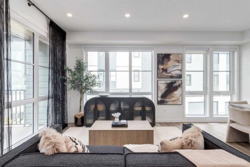 410-1453 Na'A Drive Sw, Calgary, AB - Indoor Photo Showing Living Room