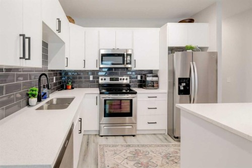 561 Canals Crossing Sw, Airdrie, AB - Indoor Photo Showing Kitchen With Double Sink With Upgraded Kitchen