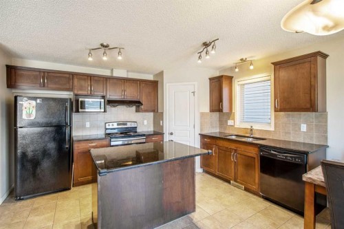 15 Kingsland Way Se, Airdrie, AB - Indoor Photo Showing Kitchen With Stainless Steel Kitchen