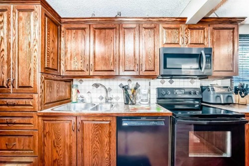 22 Glenhill Drive, Cochrane, AB - Indoor Photo Showing Kitchen With Double Sink