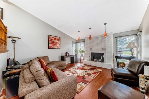 22 Glenhill Drive, Cochrane, AB - Indoor Photo Showing Living Room With Fireplace