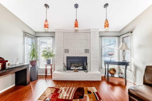 22 Glenhill Drive, Cochrane, AB - Indoor Photo Showing Living Room With Fireplace