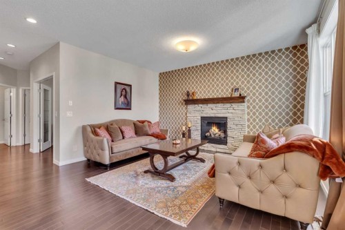 1544 Panatella Boulevard Nw, Calgary, AB - Indoor Photo Showing Living Room With Fireplace