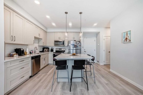 310-150 Shawnee Square, Calgary, AB - Indoor Photo Showing Kitchen With Stainless Steel Kitchen With Double Sink With Upgraded Kitchen