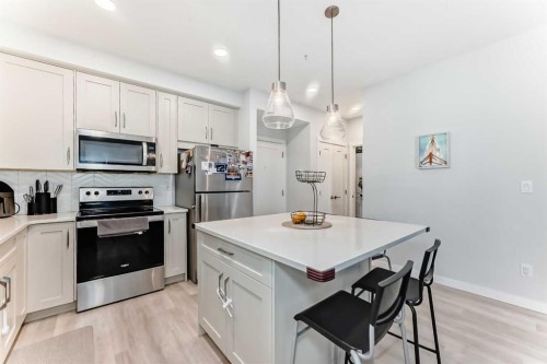 310-150 Shawnee Square, Calgary, AB - Indoor Photo Showing Kitchen With Stainless Steel Kitchen With Upgraded Kitchen