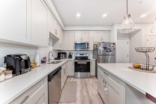310-150 Shawnee Square, Calgary, AB - Indoor Photo Showing Kitchen With Stainless Steel Kitchen With Double Sink