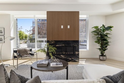 102-88 Waterfront Mews Sw, Calgary, AB - Indoor Photo Showing Living Room With Fireplace