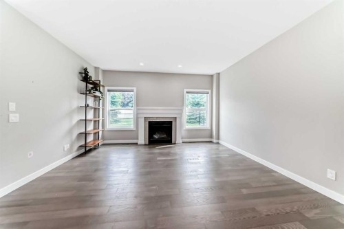 41 Shawnee Green Sw, Calgary, AB - Indoor Photo Showing Living Room With Fireplace