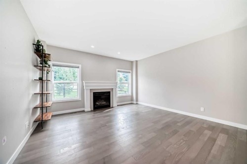 41 Shawnee Green Sw, Calgary, AB - Indoor Photo Showing Living Room With Fireplace