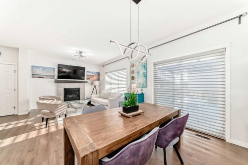 114 Walgrove Green Se, Calgary, AB - Indoor Photo Showing Dining Room With Fireplace