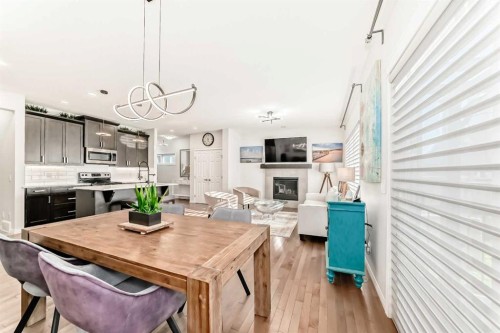 114 Walgrove Green Se, Calgary, AB - Indoor Photo Showing Dining Room With Fireplace