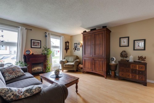 87 Falton Close Ne, Calgary, AB - Indoor Photo Showing Living Room With Fireplace