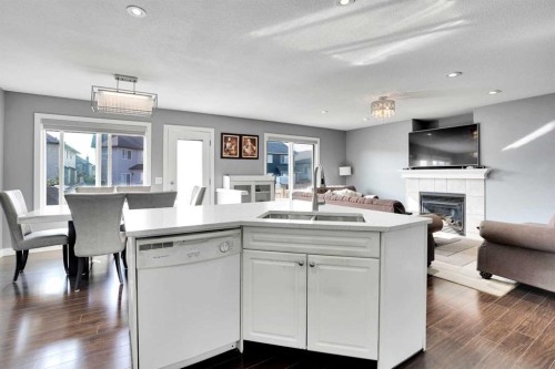 151 Saddlehorn Close Ne, Calgary, AB - Indoor Photo Showing Kitchen With Fireplace