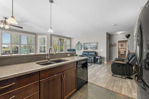 129-1 Crystal Green Lane, Okotoks, AB - Indoor Photo Showing Kitchen With Double Sink