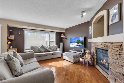 164 Covepark Close Ne, Calgary, AB - Indoor Photo Showing Living Room With Fireplace