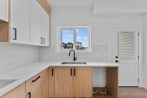 129 Heritage Boulevard, Cochrane, AB - Indoor Photo Showing Kitchen With Double Sink