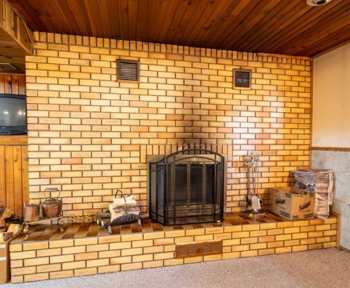 262022 Hwy 27, Rural Kneehill County, AB - Indoor Photo Showing Other Room With Fireplace