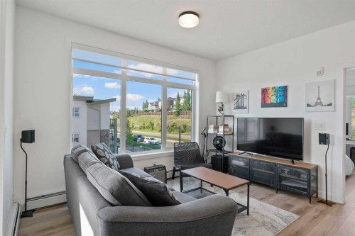 217-205 Spring Creek Common Sw, Calgary, AB - Indoor Photo Showing Living Room