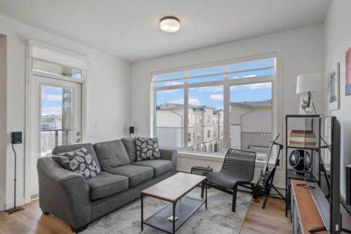 217-205 Spring Creek Common Sw, Calgary, AB - Indoor Photo Showing Living Room