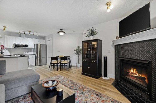 210-10 Sierra Morena Mews Sw, Calgary, AB - Indoor Photo Showing Living Room With Fireplace