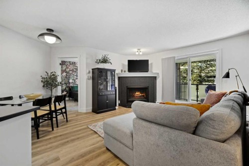 210-10 Sierra Morena Mews Sw, Calgary, AB - Indoor Photo Showing Living Room With Fireplace