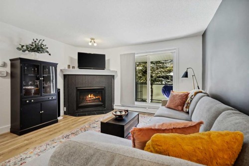 210-10 Sierra Morena Mews Sw, Calgary, AB - Indoor Photo Showing Living Room With Fireplace