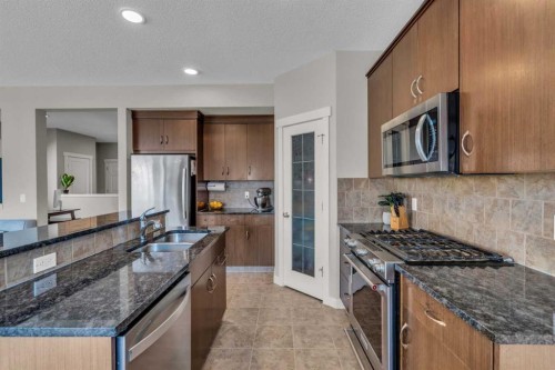 57 Silverado Skies Drive Sw, Calgary, AB - Indoor Photo Showing Kitchen With Double Sink With Upgraded Kitchen