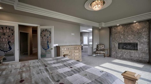 57 Edelweiss Point Nw, Calgary, AB - Indoor Photo Showing Bedroom With Fireplace