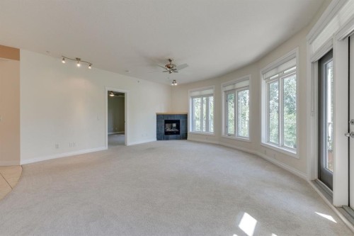 304-10 Hemlock Crescent Sw, Calgary, AB - Indoor Photo Showing Living Room With Fireplace
